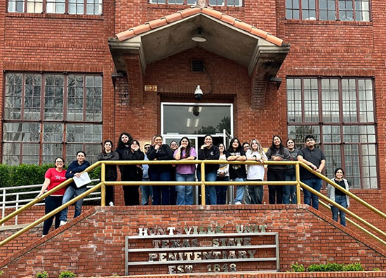 Lone Star College-University Park criminal justice students gather on the steps of the Huntsville Unit, ready to embark on an educational tour that bridges classroom theory with the realities of the correctional system.