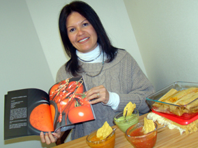 Patty Baker holding her book salsa bowls chips and tamales