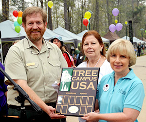 LSC-Montgomery receives Tree Campus USA recognition from John Warner, district urban forester with Texas A&M Forest Service during last month's Texas Wildlife & Woodland Expo event. Also pictured are (center) Linda Corbin, director of facilities at LSC-Montgomery, and Pat Sendelbach, interim vice president of administrative services at LSC-Montgomery.