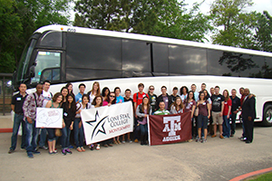 transfer students in front of the bus