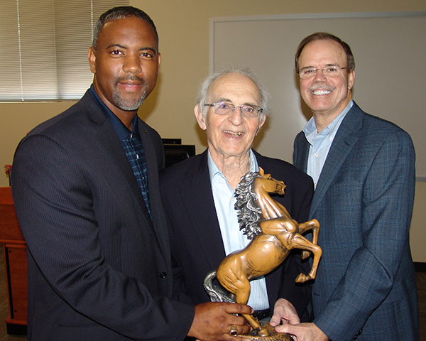 Dr. David Gottlieb, Dr. Lane, and Robert Marling holding a horse statue