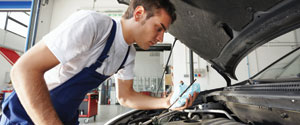 Image of man working on car