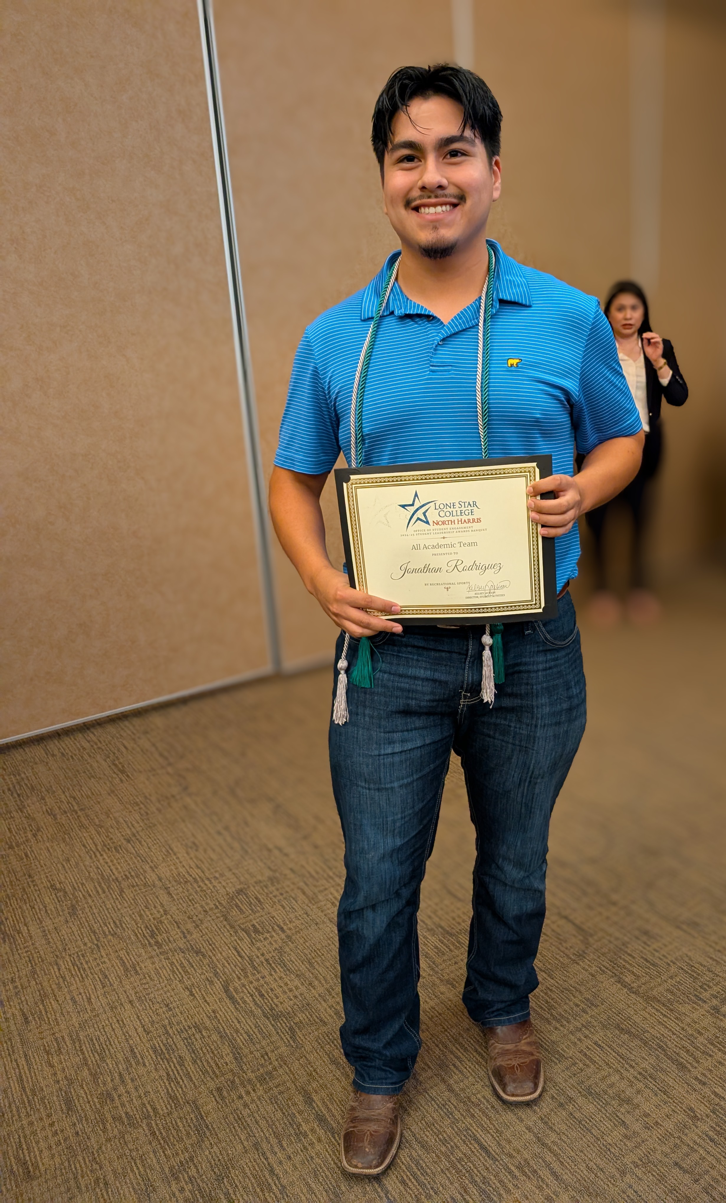 Student holding award