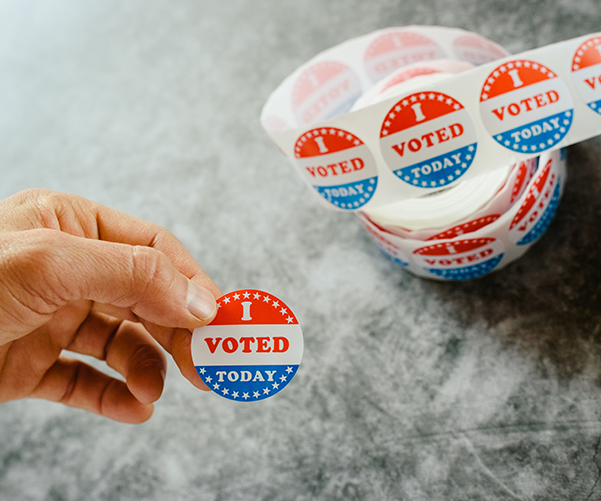 Hand holding an I voted sticker.