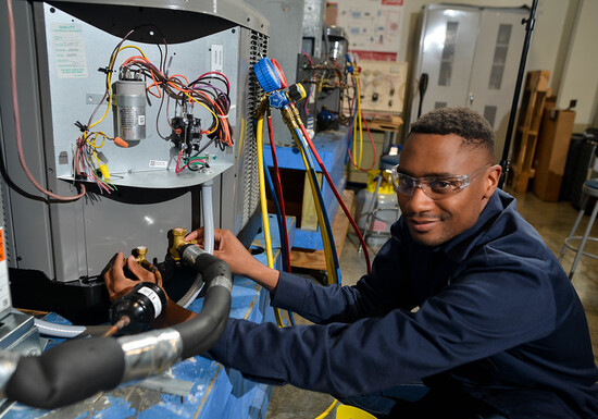 LSC-North Harris student working on HVAC unit.