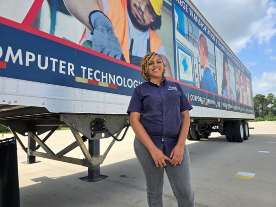 Laurye Lewis, former LSC-North Harris Student, stands in front of a trailer.