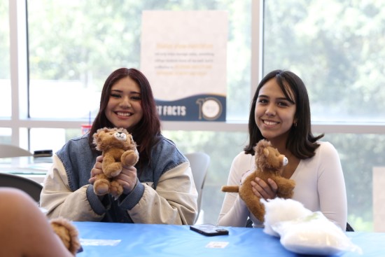 Female Students with Lion Stuffed Animals