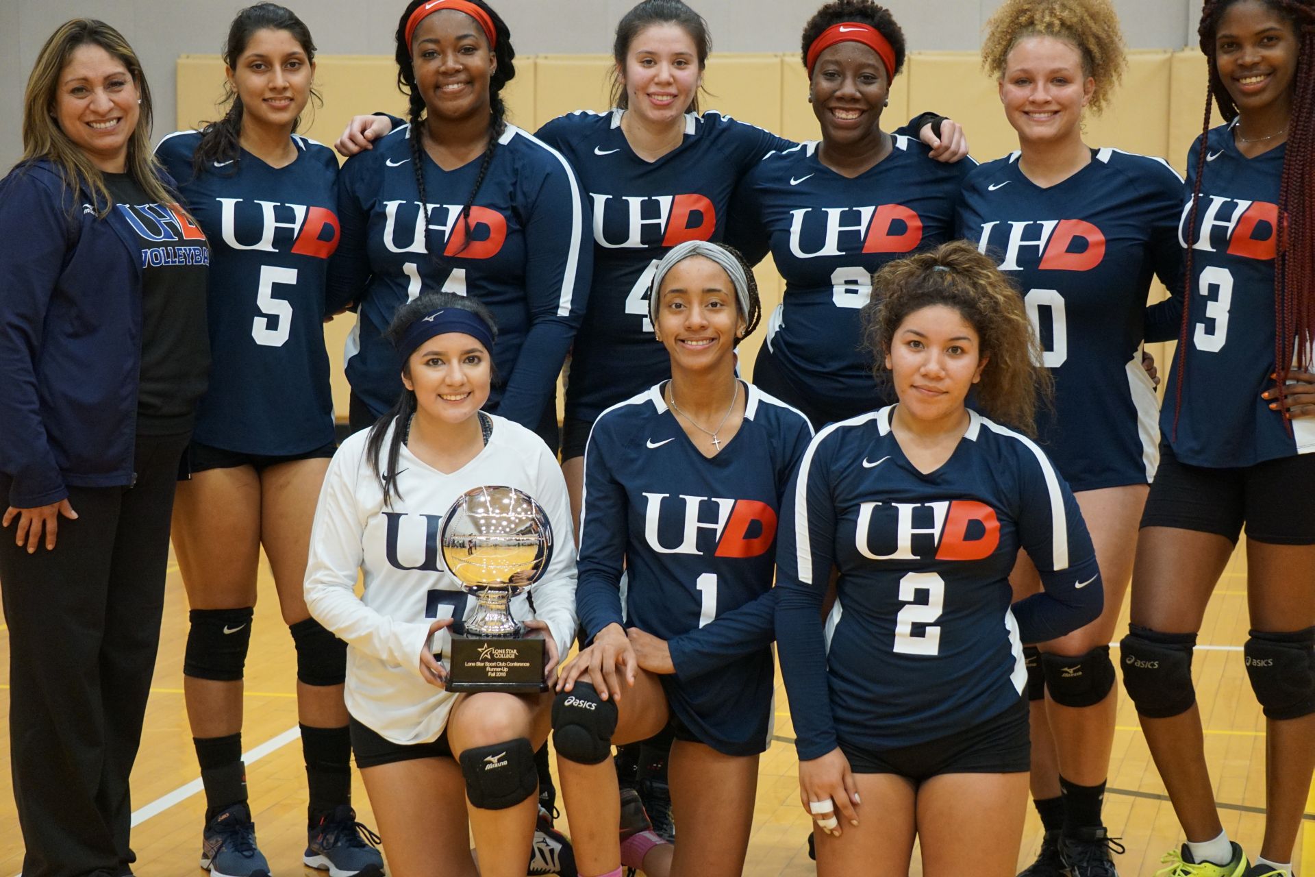 Photo of students from UofH-Downtown team with a trophy
