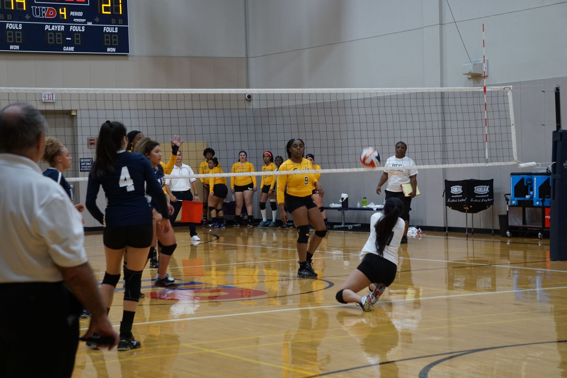 Photo of students from two different teams playing volleyball