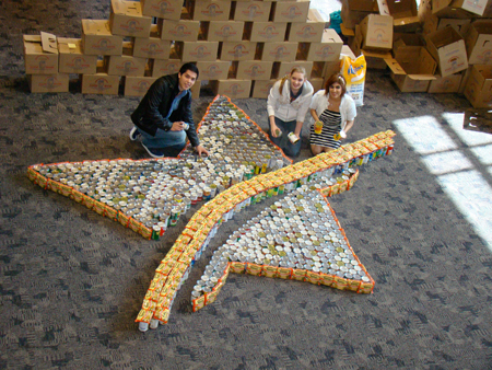 Pictured placing the cans into the Lone Star College "Star of Tomorrow" logo design are students (l. to r.): Julio Maldonado, The Woodlands; Anna Mayfield, Conroe; and Angela Ghazi, Magnolia.