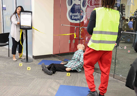  A carefully staged mock crime scene featuring a mannequin as a victim, simulated blood spatters, complete with crime scene tape and evidence markers, serves as a hands-on learning tool at the True Crime Camp held at LSC-University Park on April 3, 2024.