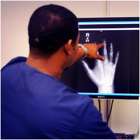 Man's back pointing finger at x-ray