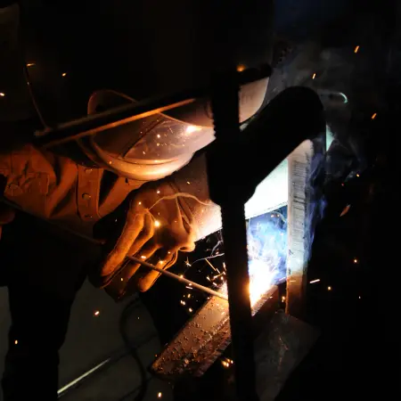 dark tight shot of someone welding