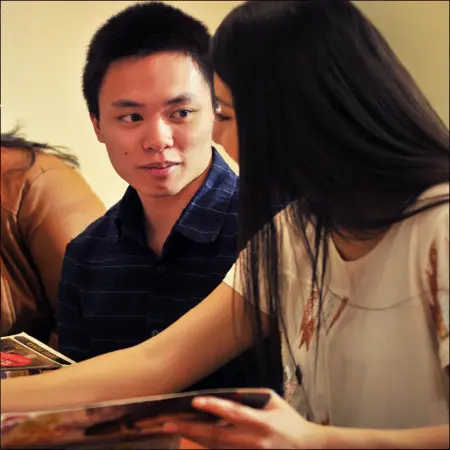 2 students working at a table