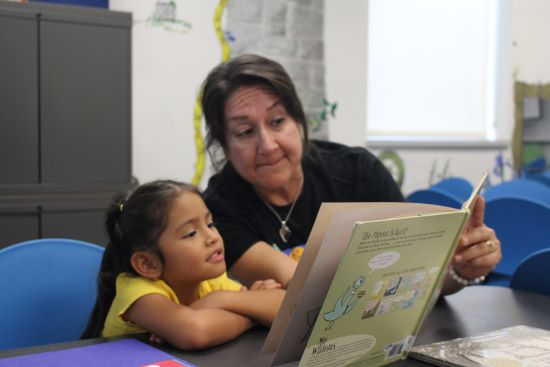 Book Buddy volunteer reading with a child.