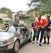 Photo of Student standing around a DeLorean car