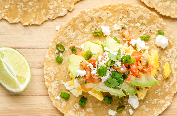 Photo of a Taco with lime, avocado, egg, and pico