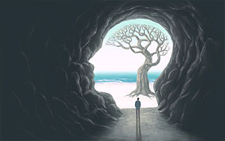 Image of a man standing in a head-shaped cave, at a tree whose branches suggest a brain