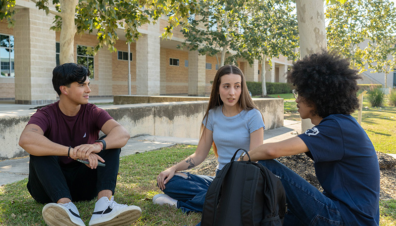 LSC-CyFair students sitting and talking on our beautiful campus