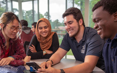 Group of happy students sitting and talking