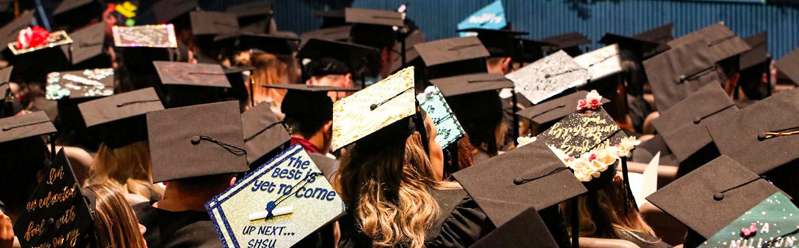 Students wearing Caps and Gowns some decorated