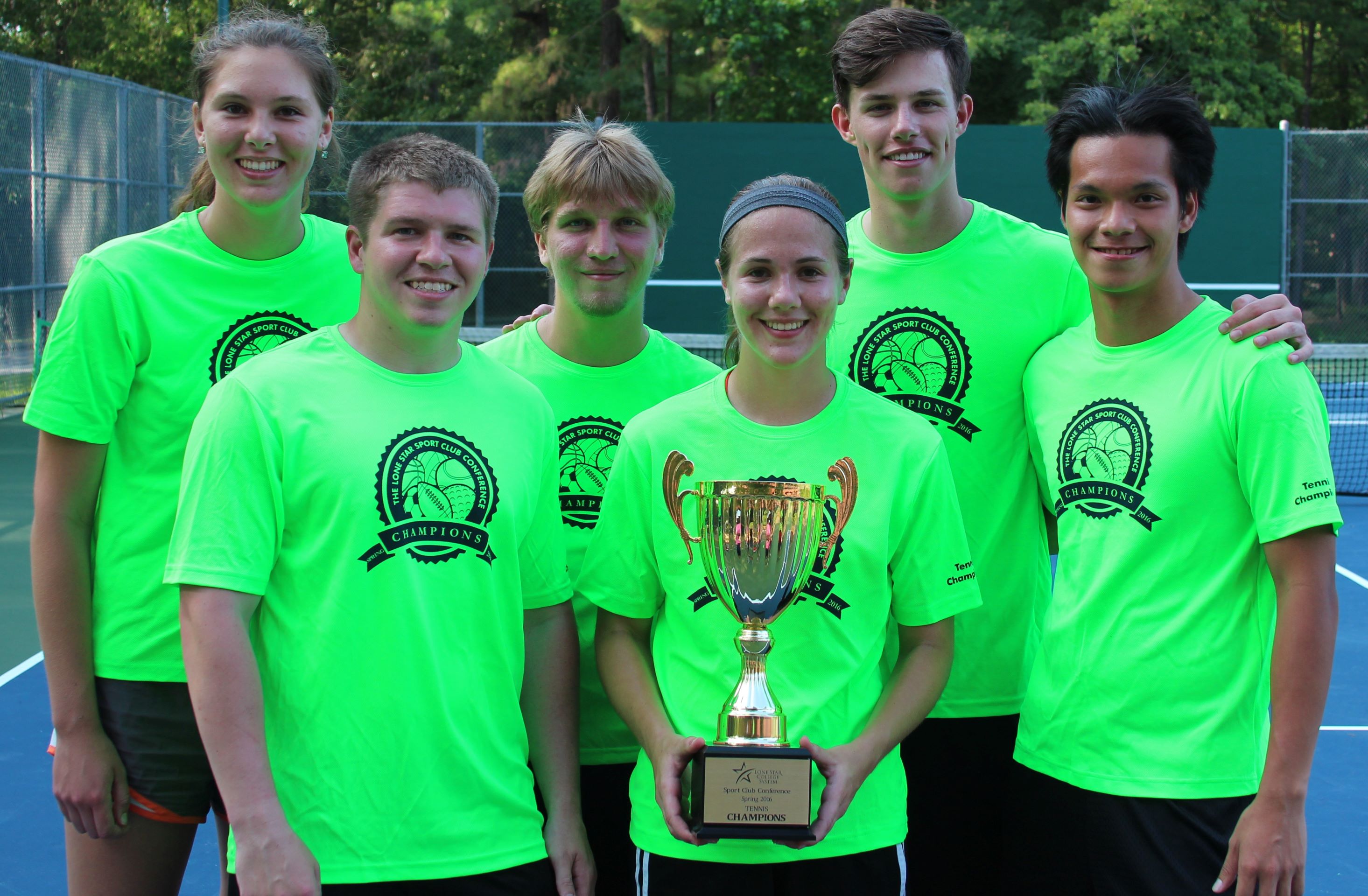 Photo of students from UofH posing for a photo with a trophy