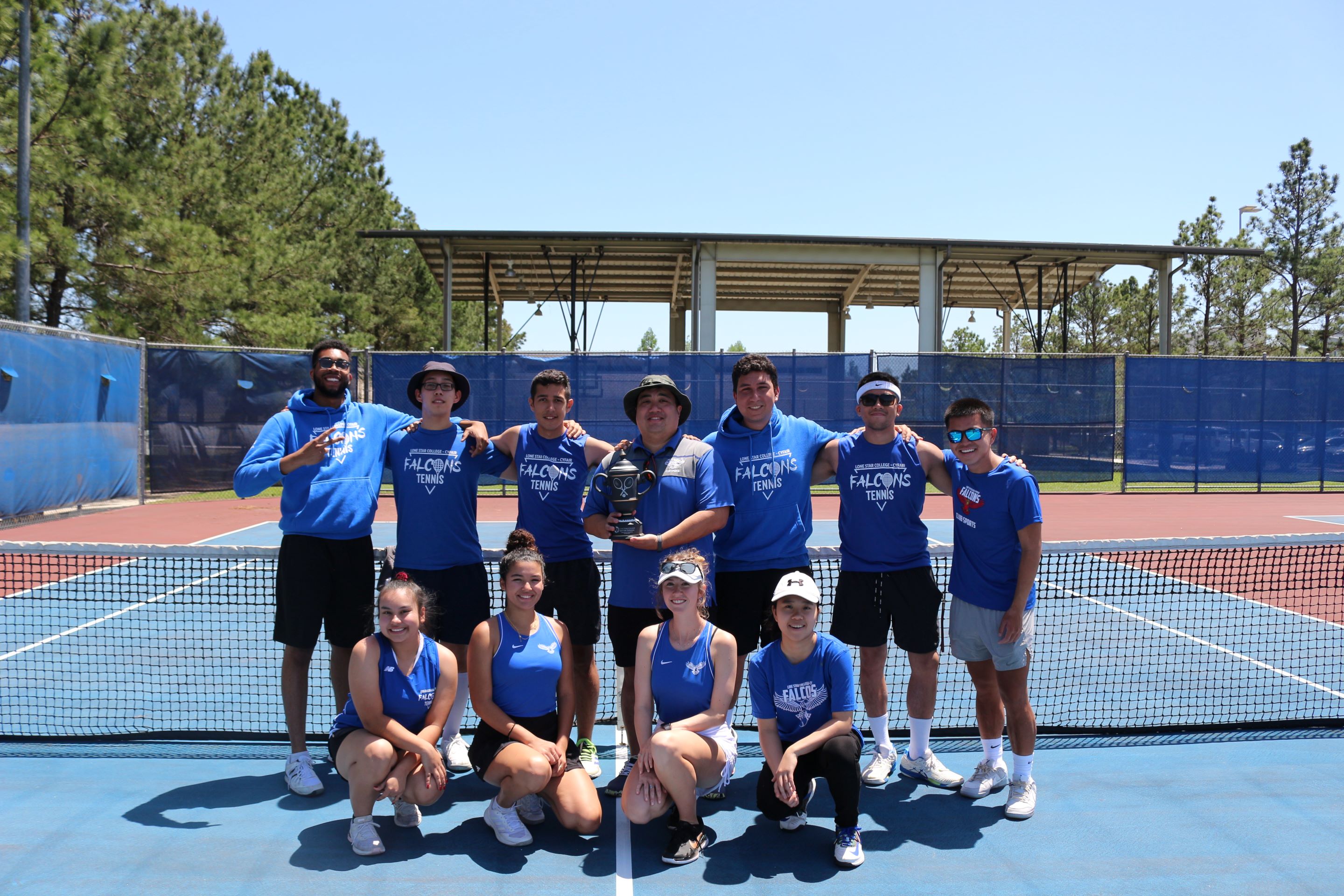 Photo of students from Sam Houston State University posing for a photo with a trophy