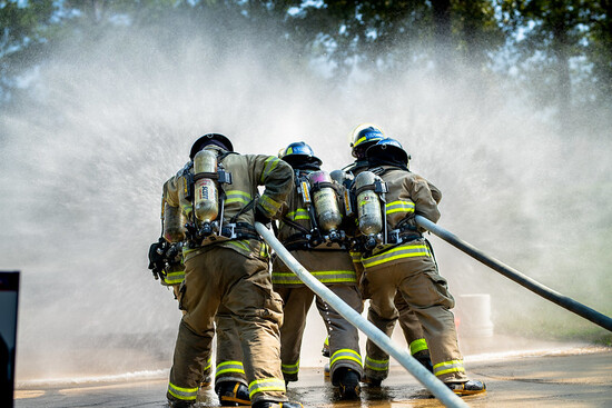 Photo of Firefighters using hose