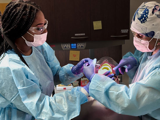 Two female students dental program