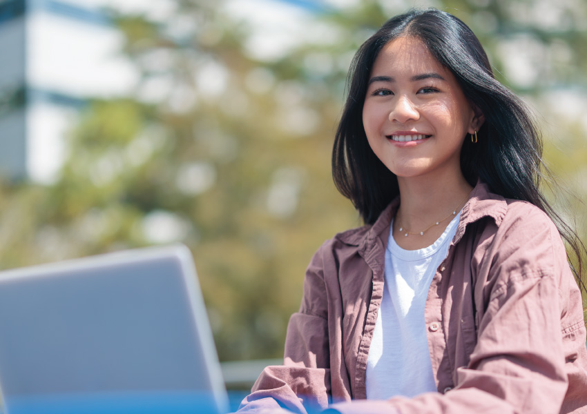 student-with-laptop-outside