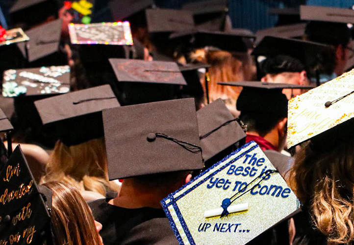 Students wearing Caps and Gowns some decorated