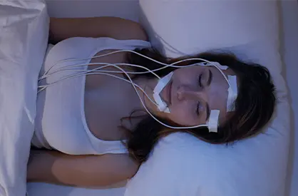 Woman in bed with sensors attached