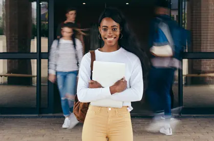 Highschool student standing holding books